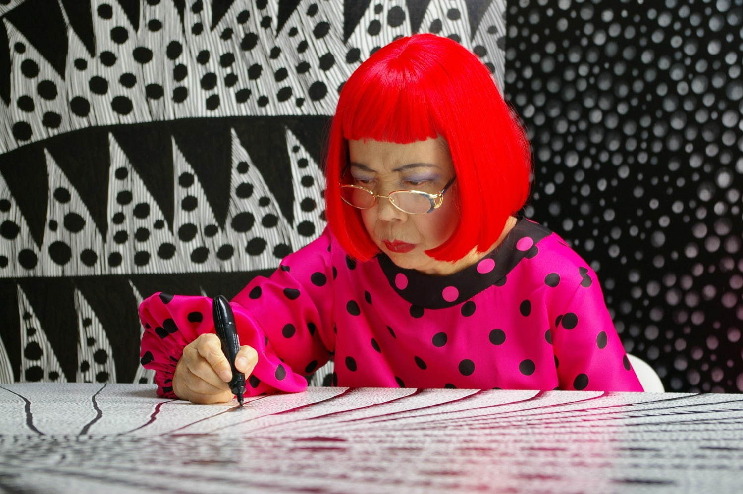 Artist Yayoi Kusama drawing in KUSAMA -INFINITY.
 © Tokyo Lee Productions, Inc. Courtesy of Magnolia Pictures.