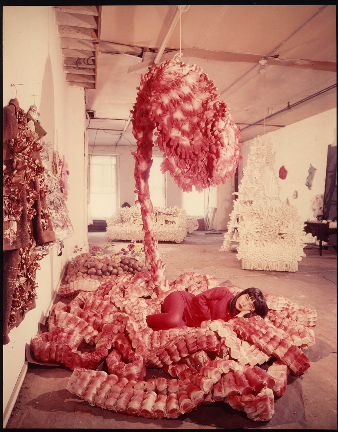 Peter Moore, Photo of Yayoi Kusama with "My Flower Bed" in her NYC studio, c. 1965 
© 2018 Barbara Moore / Licensed by VAGA at Artists Rights Society (ARS), NY, Courtesy Paula Cooper Gallery, New York.